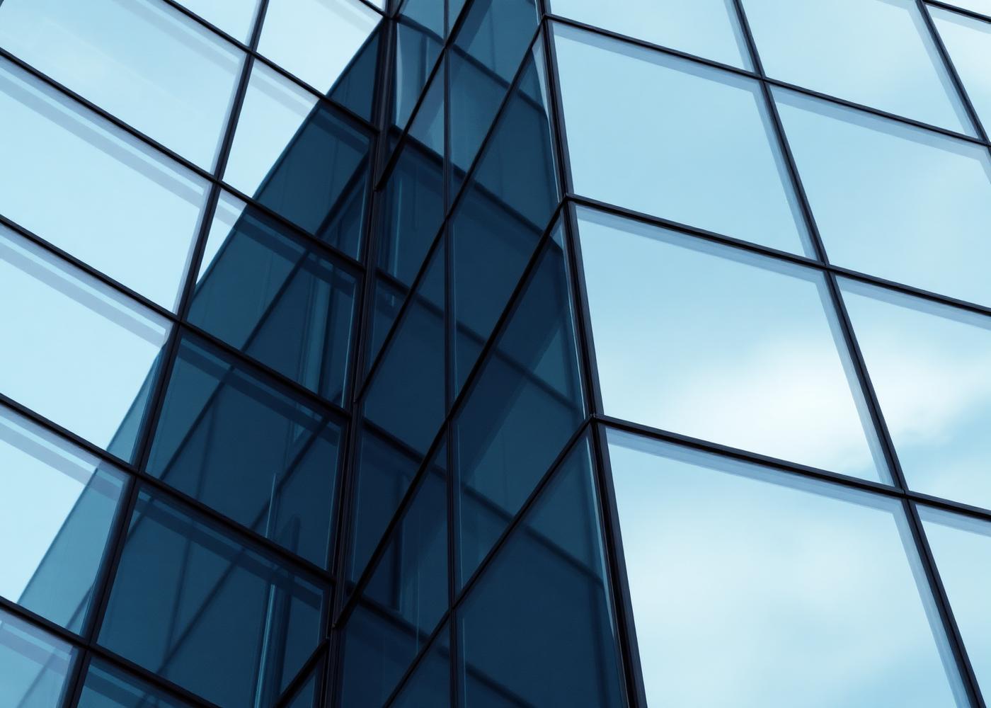 Modern glass building facade with structural geometry